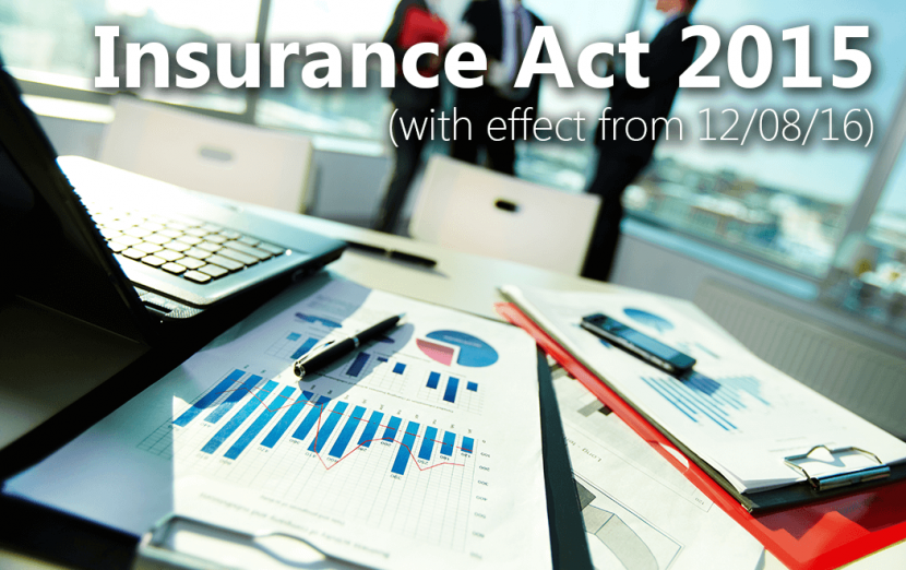 A shot of formal paperwork, a pen, a laptop, a phone and a clipboard in sharp focus, with business employees blurred out in the background.