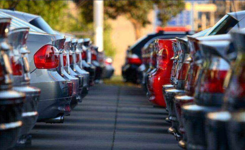 Rows of vehicles line the image with the boots in view either side.