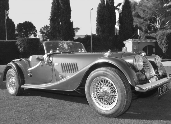 A black and white photo of a Morgan sports car.
